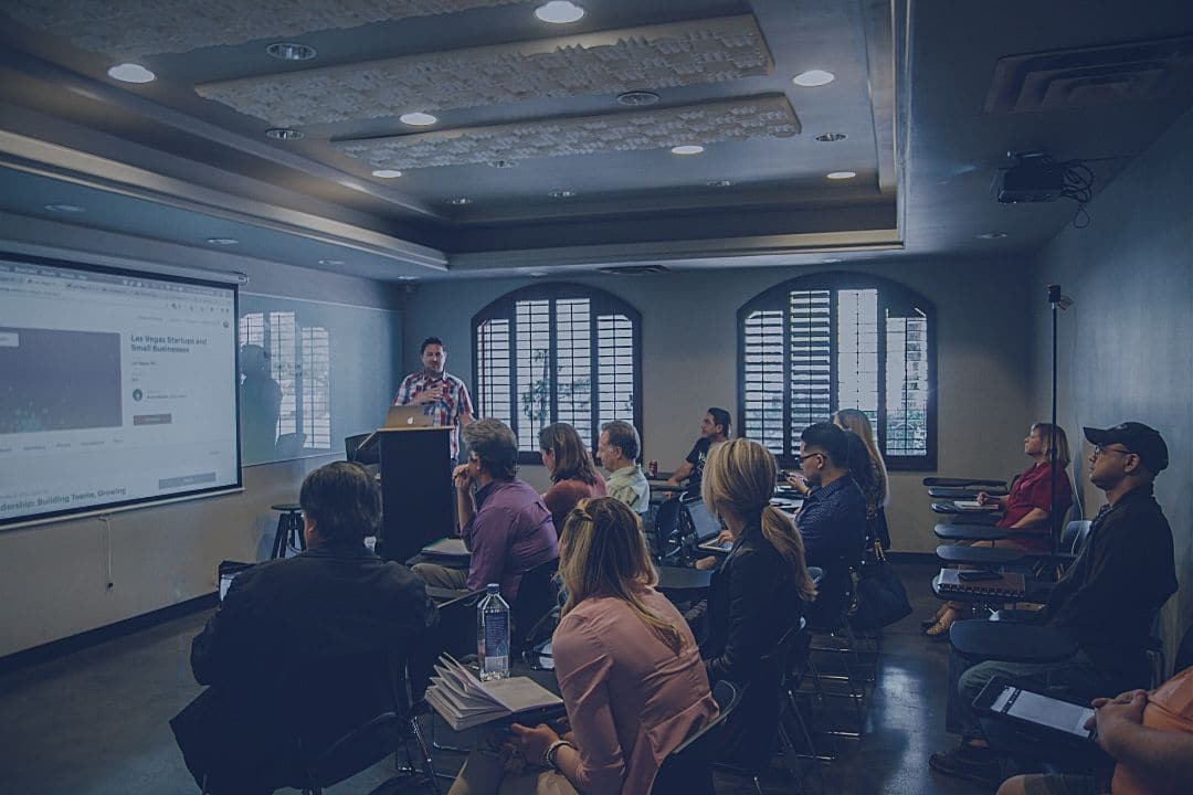 students in a classroom listening to their instructor lecture