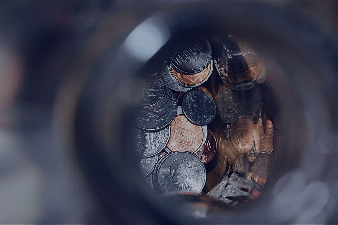 Glass jar filled with coins