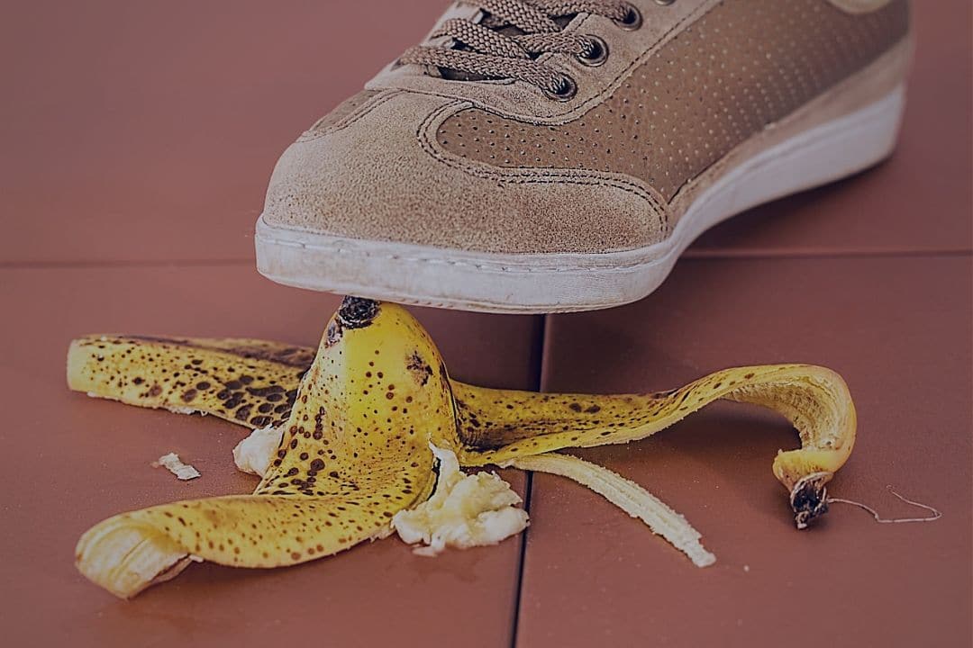 Shoe stepping on banana peel