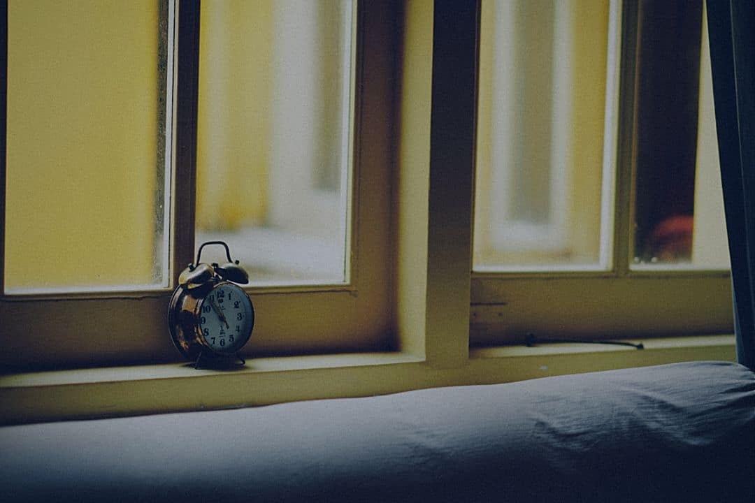 alarm clock on window sill