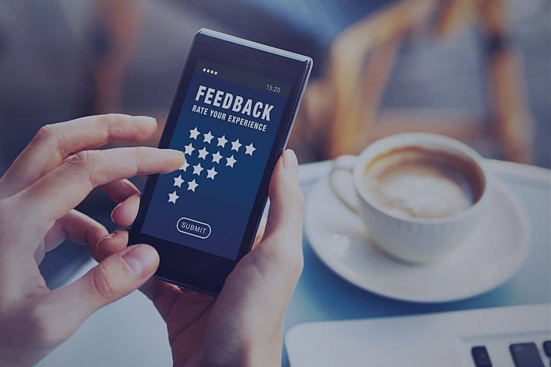 Person composing review on smartphone