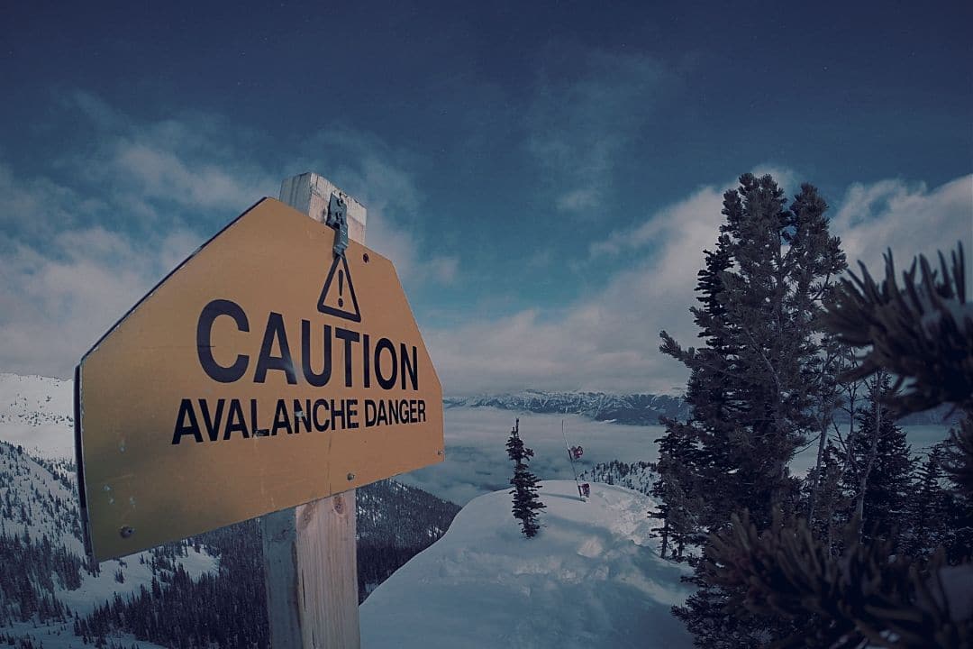 caution sign on snowy mountain
