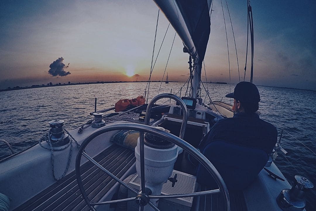 sailboat on water at sunset