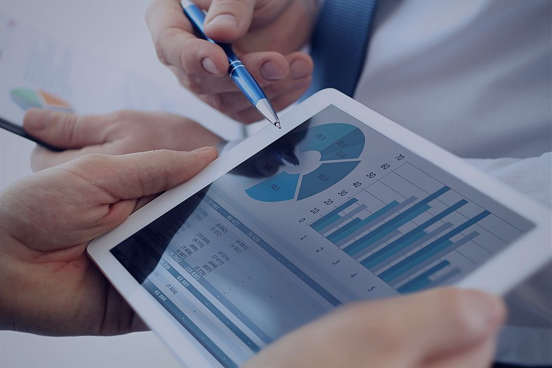 Man looking on analytics dashboard on tablet