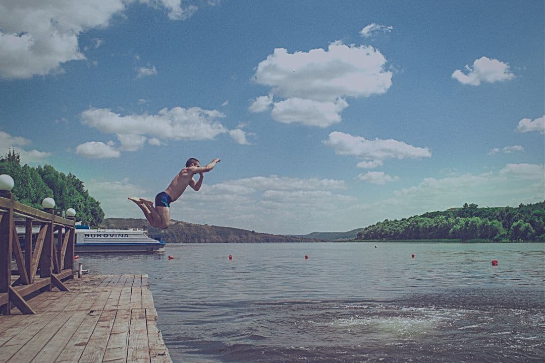 Man jumping into lake