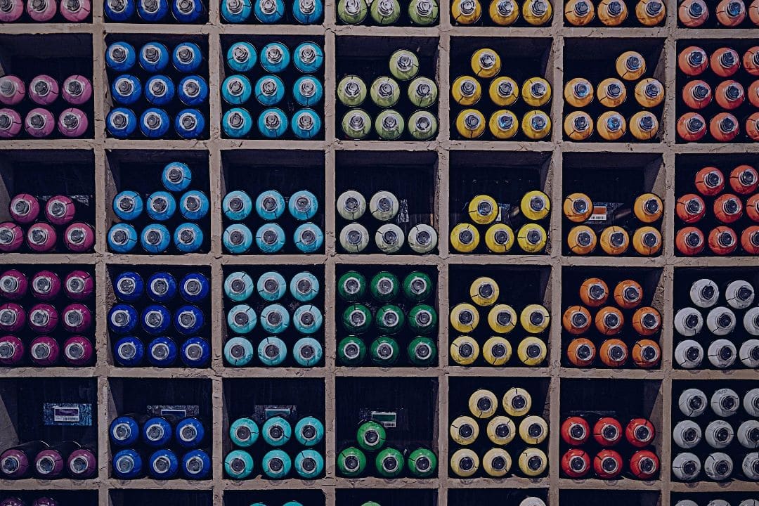 Paints organized by color in cabinet