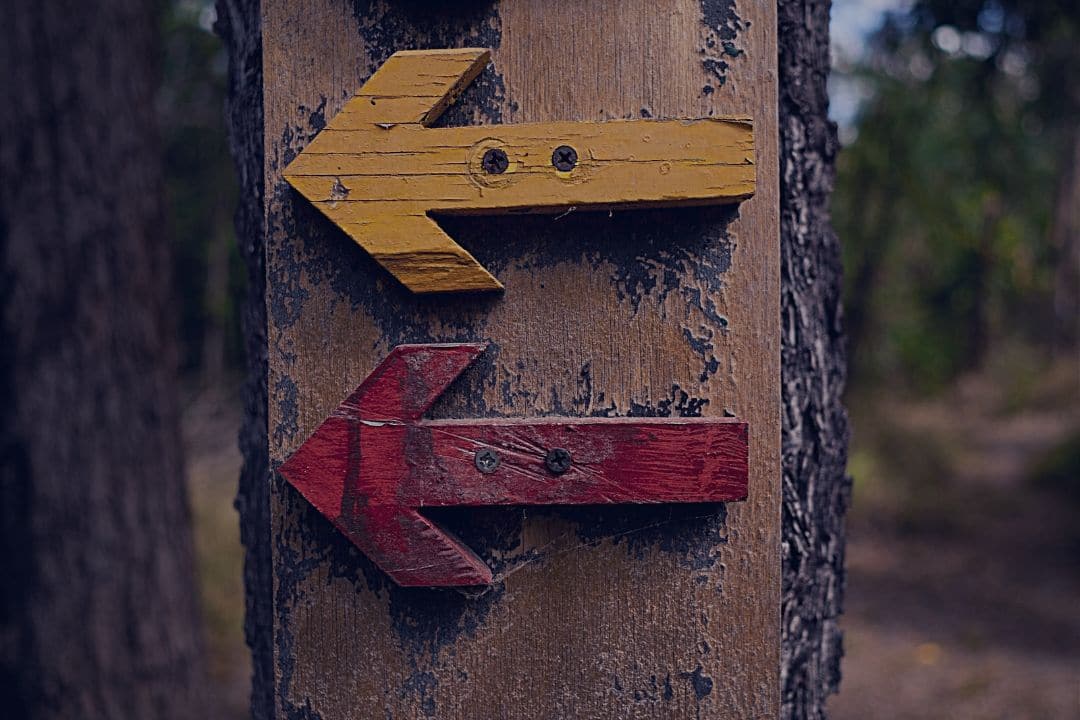 Wooden arrows on post