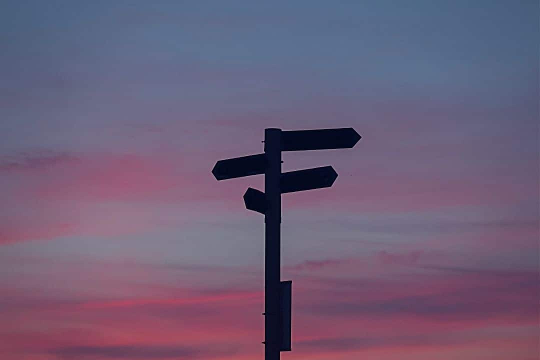 Sign posts in front of the sunset