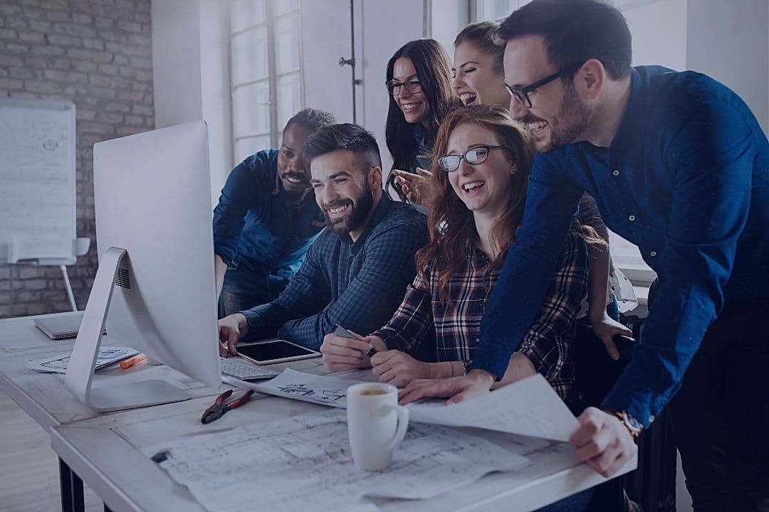 coworkers around a computer